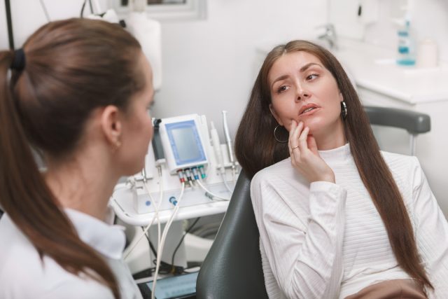 patient at dentist consulting about tooth pain