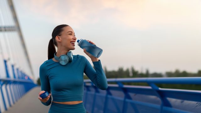 female jogger drinking water