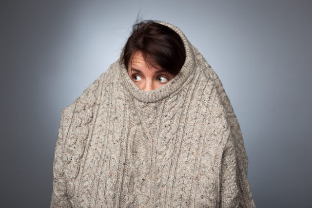 woman hiding in sweater